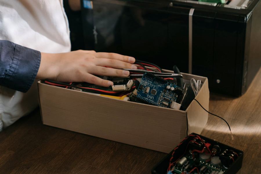 Electronic hardware components being packed into a box for despatch