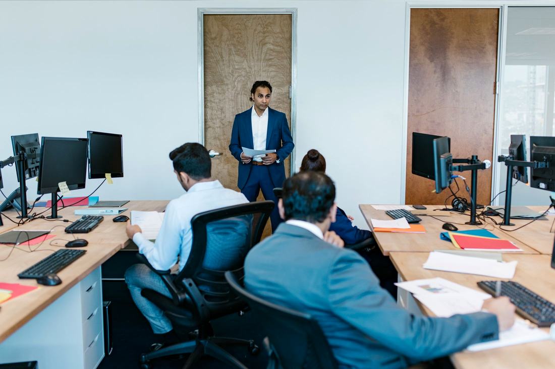 Staff at workstations on an office floor supplied and deployed for a customer