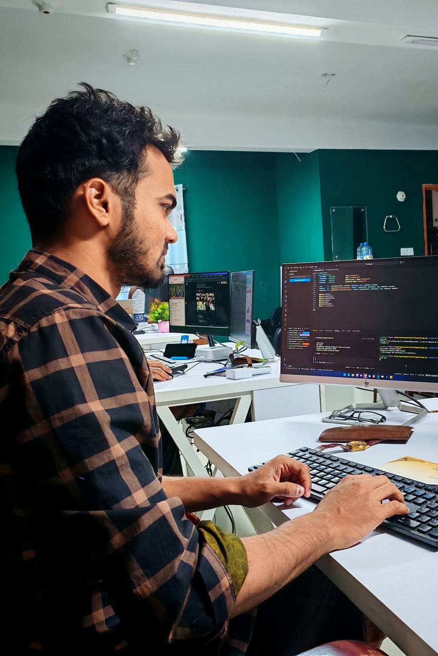 Developer using licensed software on a managed dual-monitor workstation