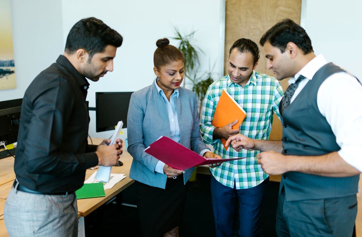 Colleagues reviewing documents together in the office