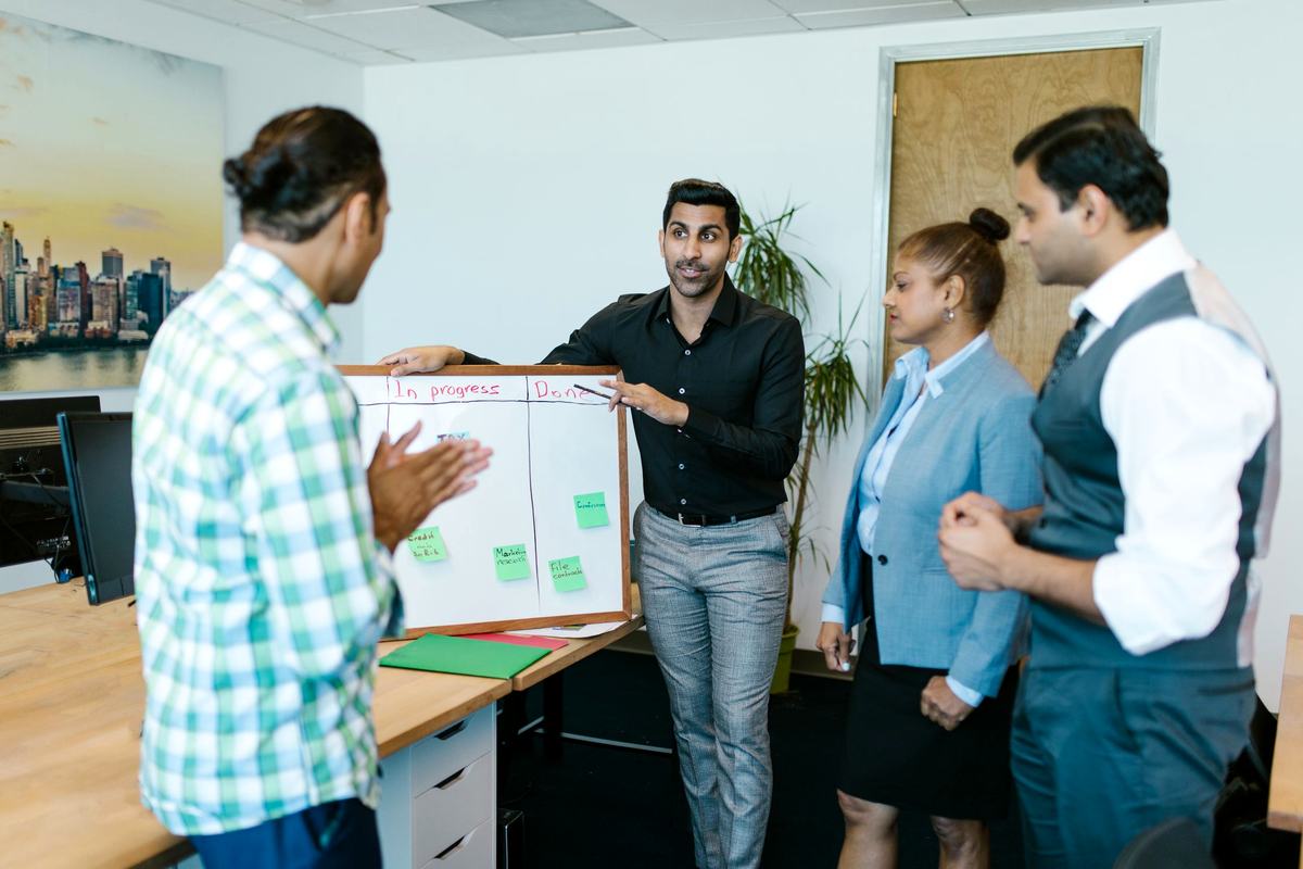 Project team walking through a deployment plan at a whiteboard